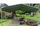A covered parking area with a view to the house, the backyard, and the wooded landscape at 5083 Fleetwood Dr, Hickory, NC 28602