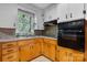 Kitchen close-up featuring wood cabinets, updated appliances, and a window at 5083 Fleetwood Dr, Hickory, NC 28602