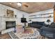 Inviting living room with a stone fireplace, ceiling fan, and wood-look flooring at 5083 Fleetwood Dr, Hickory, NC 28602