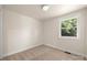 Cozy bedroom featuring neutral carpet and a bright window overlooking the outside at 517 Dutch Ave, Mount Holly, NC 28120
