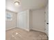 Neutral carpeted bedroom with closet and window to let in natural light at 517 Dutch Ave, Mount Holly, NC 28120