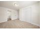 Spacious bedroom featuring neutral carpet and a double door closet with bathroom access at 517 Dutch Ave, Mount Holly, NC 28120