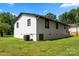 Side view of home featuring vinyl siding, black window trim, and brick foundation at 517 Dutch Ave, Mount Holly, NC 28120