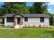 Charming ranch-style home with a well-maintained lawn, a brick foundation, and a welcoming front porch at 517 Dutch Ave, Mount Holly, NC 28120