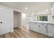 Bright, open kitchen with white cabinets, solid surface countertops, and wood-look flooring at 517 Dutch Ave, Mount Holly, NC 28120