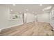 Open concept with wood-look floors, recessed lights, and view into the kitchen with a white breakfast bar at 517 Dutch Ave, Mount Holly, NC 28120