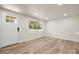 Bright living room featuring wood-look floors, a window, white walls, recessed lighting, and a front door at 517 Dutch Ave, Mount Holly, NC 28120