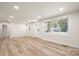Open concept living space with wood-look floors, white trim, a new front door, and multiple windows at 517 Dutch Ave, Mount Holly, NC 28120