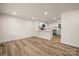 Open concept living space with wood-look floors and views into the kitchen with a white breakfast bar at 517 Dutch Ave, Mount Holly, NC 28120