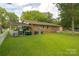 Brick home's backyard with covered area, grill, storage, and a lush green lawn for outdoor enjoyment at 517 Fieldcrest Dr, Chester, SC 29706