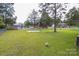 A spacious backyard is equipped with basketball court and lawn for outdoor activities at 517 Fieldcrest Dr, Chester, SC 29706