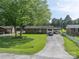 Charming single-story brick home with a well-manicured lawn and a spacious driveway at 517 Fieldcrest Dr, Chester, SC 29706