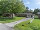 Inviting single-story brick home featuring a lush front lawn and ample parking space at 517 Fieldcrest Dr, Chester, SC 29706