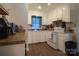 The clean kitchen is bright with white cabinets and updated appliances for modern convenience at 517 Fieldcrest Dr, Chester, SC 29706
