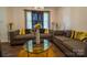 Bright and inviting living room with elegant sofas, a glass coffee table, and natural light at 517 Fieldcrest Dr, Chester, SC 29706