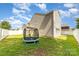 Grassy backyard featuring a privacy fence and a trampoline, offering a private outdoor space at 523 Smokehouse Ln, Albemarle, NC 28001