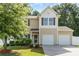 Charming two-story home featuring a two-car garage, well-maintained lawn and manicured landscaping at 523 Smokehouse Ln, Albemarle, NC 28001
