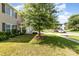 Well-maintained front yard with lush green lawn, mature tree, and tidy landscaping, enhancing curb appeal in a residential street at 523 Smokehouse Ln, Albemarle, NC 28001