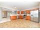 Kitchen featuring wooden cabinets, stainless steel appliances, tile flooring, and an open layout at 523 Smokehouse Ln, Albemarle, NC 28001