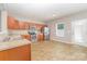 Kitchen featuring wooden cabinets, stainless steel appliances, tile flooring, and an adjacent dining area at 523 Smokehouse Ln, Albemarle, NC 28001
