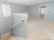 Second floor landing with natural light, neutral carpet, and access to additional rooms at 523 Smokehouse Ln, Albemarle, NC 28001