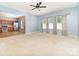 Spacious living room features large windows, neutral carpet, and flows into the kitchen at 523 Smokehouse Ln, Albemarle, NC 28001