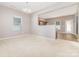 Bright, open living room featuring neutral carpet, gray walls and access to the kitchen at 523 Smokehouse Ln, Albemarle, NC 28001