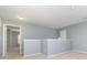 Open loft area with neutral walls and carpet, leading to an adjacent room, perfect for a home office or playroom at 523 Smokehouse Ln, Albemarle, NC 28001