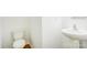 Compact half-bathroom featuring a toilet and pedestal sink, ideal for guests and convenience at 5319 Swearngan Rd, Charlotte, NC 28216