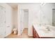 Bathroom boasts double sinks, wood-look floors, and an open doorway to the walk-in closet at 5319 Swearngan Rd, Charlotte, NC 28216