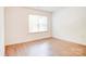 Bright bedroom featuring wood-look flooring and natural light at 5319 Swearngan Rd, Charlotte, NC 28216
