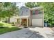 Charming two-story home with a stone-accented front porch, manicured landscaping, and a convenient attached garage at 5319 Swearngan Rd, Charlotte, NC 28216