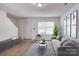 Staged living room boasting wood-look flooring, neutral tones, and stylish decor for a modern appeal at 5319 Swearngan Rd, Charlotte, NC 28216