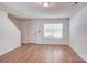 Inviting living room with wood-look flooring and ample natural light from a large window at 5319 Swearngan Rd, Charlotte, NC 28216