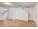 Bright living room featuring wood-look flooring, a staircase, and neutral paint, creating a welcoming atmosphere at 5319 Swearngan Rd, Charlotte, NC 28216