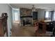 Living room featuring a stone fireplace, ceiling fan, and vintage built-ins at 5324 Weblee Ct, Kings Mountain, NC 28086