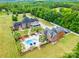 Stunning aerial view of a luxurious estate with a pool, meticulously landscaped grounds, and lush greenery at 572 W Shiloh Unity Rd, Lancaster, SC 29720