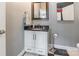 Elegant powder room with granite countertop, white cabinetry, and stylish fixtures at 572 W Shiloh Unity Rd, Lancaster, SC 29720