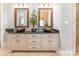 Bathroom vanity featuring dual copper vessel sinks, granite countertop, and wooden cabinets at 572 W Shiloh Unity Rd, Lancaster, SC 29720
