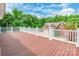 Large wood deck with white railings offering views of a lush green yard and blue sky at 572 W Shiloh Unity Rd, Lancaster, SC 29720