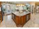 Spacious kitchen island with granite countertop, wooden cabinetry, microwave, and view to living room at 572 W Shiloh Unity Rd, Lancaster, SC 29720