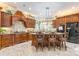 Gourmet kitchen with dark wood cabinetry, granite countertops, large island with seating, and stainless steel appliances at 572 W Shiloh Unity Rd, Lancaster, SC 29720
