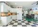 Bright kitchen with white cabinets, checkered floors, and a unique display of sports memorabilia at 572 W Shiloh Unity Rd, Lancaster, SC 29720