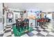 Eclectic kitchen boasts white cabinetry, checkered flooring, football themed decor, and bar seating at 572 W Shiloh Unity Rd, Lancaster, SC 29720
