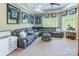 Comfortable living room with large sectional sofa, sports memorabilia, and natural light at 572 W Shiloh Unity Rd, Lancaster, SC 29720