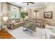 Comfortable living room with neutral tones, plush seating, and a beautiful arched window allowing natural light at 572 W Shiloh Unity Rd, Lancaster, SC 29720