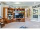 Built-in shelving houses a television and personal decor in this warm and inviting living room at 572 W Shiloh Unity Rd, Lancaster, SC 29720