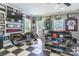 Sports-themed living room featuring a checkered floor, large TV, and motorcycle display at 572 W Shiloh Unity Rd, Lancaster, SC 29720