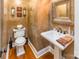 Stylish powder room featuring designer mirror, pedestal sink, and unique textured wall finish at 572 W Shiloh Unity Rd, Lancaster, SC 29720