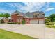 Expansive rear exterior showcases a brick home with a three-car garage and a large paved driveway at 572 W Shiloh Unity Rd, Lancaster, SC 29720
